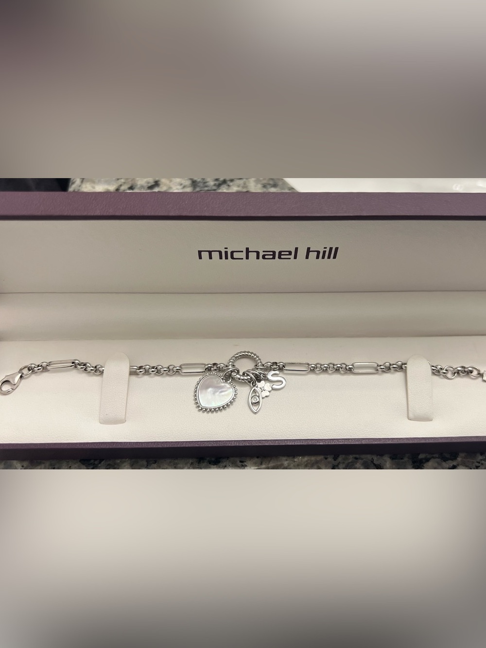 Paperclip 7 in 1 alternating open pendant charm bracelet in sterling silver.